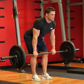 man performing the barbell row to help strengthen his biceps, glutes and lats